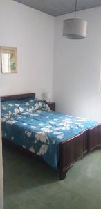1 dormitorio con 1 cama con edredón azul en Alojamiento Taravella en Córdoba