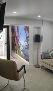 a living room with a large painting on the wall at Casa Mejías, excelente localización, cerca de los principales puntos turísticos de Antequera in Antequera