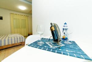 a table with a wine bottle and glasses on it at Apartments Mar in Ulcinj