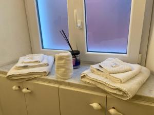 a bathroom with towels on a counter next to a window at La Finestra sul Mare in Lerici