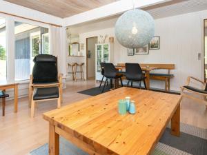 a living room with a wooden table and chairs at 7 person holiday home in Grenaa in Grenå