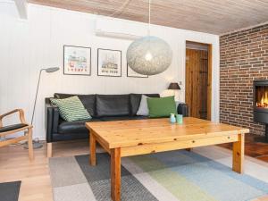 a living room with a couch and a coffee table at 7 person holiday home in Grenaa in Grenå