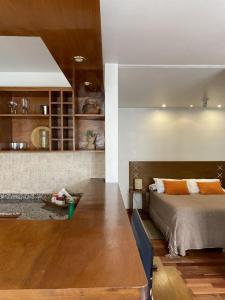 a bedroom with a bed and a wooden table at Santa Fe Suites Apart in Salta