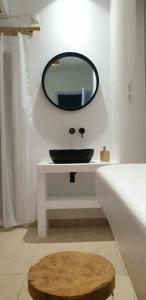 a bathroom with a black sink and a mirror at Ilias Place in Ios Chora