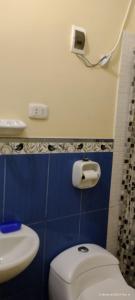 a bathroom with a white toilet and a sink at Violeta Dulce Hospedaje Familiar Privado en PACASMAYO in Pacasmayo