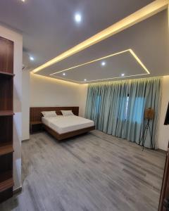 a bedroom with a bed and a large window at Giani Lodge in Lomé