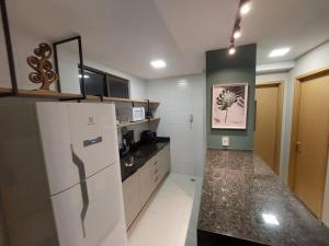 a kitchen with a refrigerator and a counter top at Flat Buenos Ayres Cabo Branco in João Pessoa