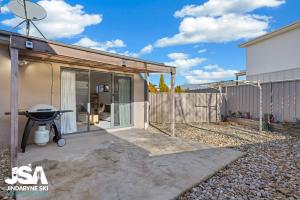 a small house with a patio and a fence at Berridale Bliss in Berridale