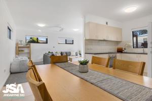 a dining room and kitchen with a table and chairs at Berridale Bliss in Berridale