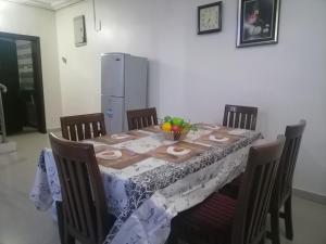 a dining room table with a table cloth on it at Luxury Homes in Port Harcourt