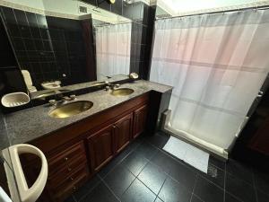 a bathroom with two sinks and a shower at Casa en SAN LUIS in San Luis +29 photos