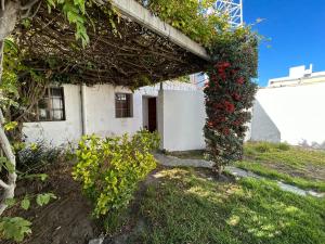 a building with a bunch of flowers on it at Casa en SAN LUIS in San Luis