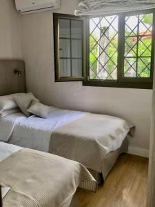Postel nebo postele na pokoji v ubytování Santa Clara Bungalows