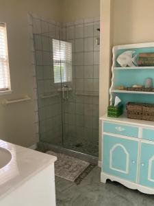 a bathroom with a glass shower with a sink at Venetian Vacation in Venice