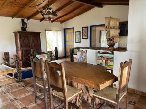 a dining room with a wooden table and chairs at Hacienda Palomas en Concordia - Finca Cafetera in Salgar