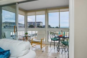 a living room with a couch and a table and chairs at San Marco Gulf Beach Views 3rd Floor in Venice +42 photos