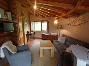 a living room with a couch and a table at Chalet en Rondins Au Cœur de la Nature avec Confort Moderne près de Strasbourg - FR-1-589-228 in Le Saulcy