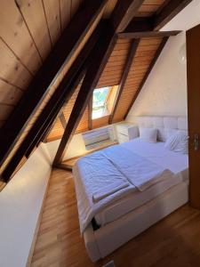 una camera da letto con un grande letto in mansarda di Private room for long term rent 1000-1200CHF per month a Bolligen
