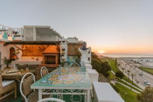 a table on a balcony with a view of the ocean at Riad Villa with Mediterranean Sea Views of Spain and Gibraltar in Tangier
