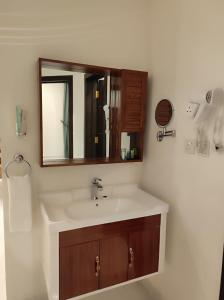 a bathroom with a sink and a mirror at Kyan Park Abha Hotel in Abha