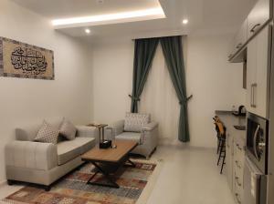 a living room with a couch and a table at Kyan Park Abha Hotel in Abha