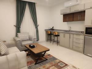 a living room with a couch and a table at Kyan Park Abha Hotel in Abha