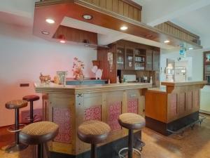 a kitchen with a bar with stools at Cosy holiday home in Sankt Goarshausen with barbecue in Sankt Goarshausen