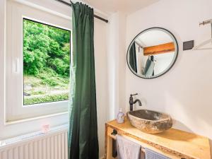 a bathroom with a sink and a window at Cosy holiday home in Sankt Goarshausen with barbecue in Sankt Goarshausen