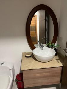 a bathroom with a white sink and a mirror at NEW! Modern 2b La Carolina AmazingView 3c in Quito