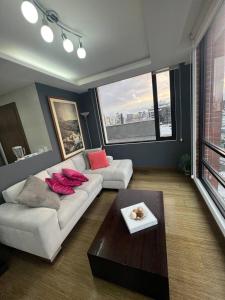 a living room with a couch and a coffee table at NEW! Modern 2b La Carolina AmazingView 3c in Quito