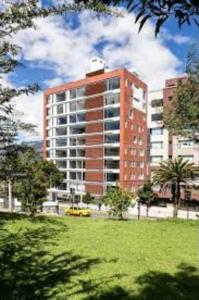 a tall red brick building in a park at NEW! Modern 2b La Carolina AmazingView 3c in Quito