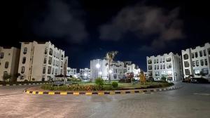 a group of white buildings in a city at night at Pharma beach resort قريه الصيادلة - Chalet - zero ten six four one seven six five zero nine in Balṭîm