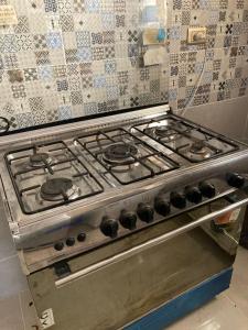 a stove top oven sitting in a kitchen at Pharma beach resort قريه الصيادلة - Chalet - zero ten six four one seven six five zero nine in Balṭîm