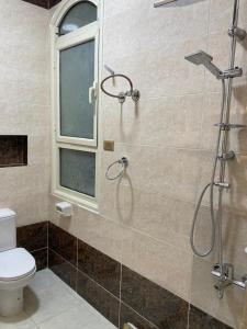 a bathroom with a shower and a toilet at Pharma beach resort قريه الصيادلة - Chalet - zero ten six four one seven six five zero nine in Balṭîm