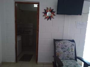 a room with a chair and a sign on the wall at El secreto de la vida in Villa de Soto