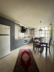 a kitchen and dining room with a table and refrigerator at İsra Suit in Trabzon