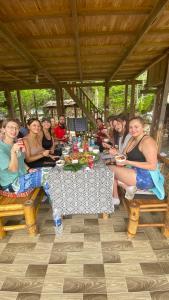 a group of people sitting at a table at Meadow Mai Chau Homestay in Mai Chau
