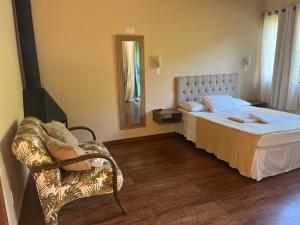 Cama ou camas em um quarto em Lumiar Chalé Jardim do Sossego