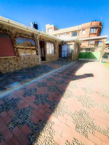 an empty street in front of a brick building at Cabañas Utama in Copacabana