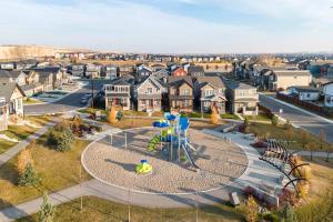an aerial view of a residential neighborhood with a playground at Luxurious Comfortable Suite in Airdrie