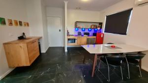 a kitchen with a table and chairs in a room at The Good Life in Port Pirie