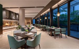 三亞的住宿－三亚山海天雅诗阁服务公寓，用餐室设有桌椅和窗户。
