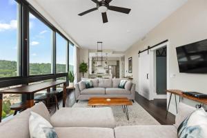 a living room with a couch and a table at 'Cloud 10' A Luxury Downtown Condo with Panoramic City and Mountain Views at Arras Vacation Rentals in Asheville