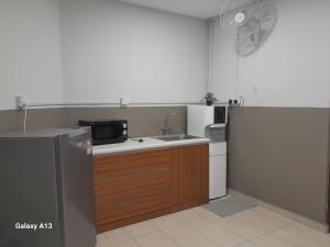 a kitchen with a sink and a microwave at The Great Hotel in Ipoh
