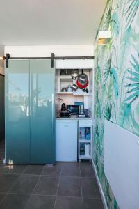 a kitchen with a sliding door in a room at Studio Sal in Albufeira