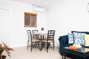 a living room with a table and chairs and a couch at Sheer Bliss BeachView Apt #2 in Exuma Harbour Estates