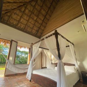 a bedroom with a bed with a hammock at Hotel Reserva de Piedemonte in Villavicencio