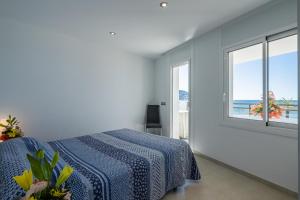 a bedroom with a bed and a view of the ocean at Inmosantos Oasis F5 in Roses +45 photos