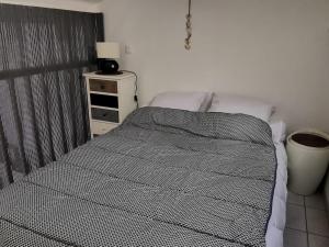 a bedroom with a bed and a night stand at Appartement cosy à 100m de la plage avec mezzanine, terrasse et parking privatif - FR-1-194-263 in La Tranche-sur-Mer