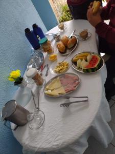 a white table with food on top of it at Pousada Trilha do Pelo in Salvador